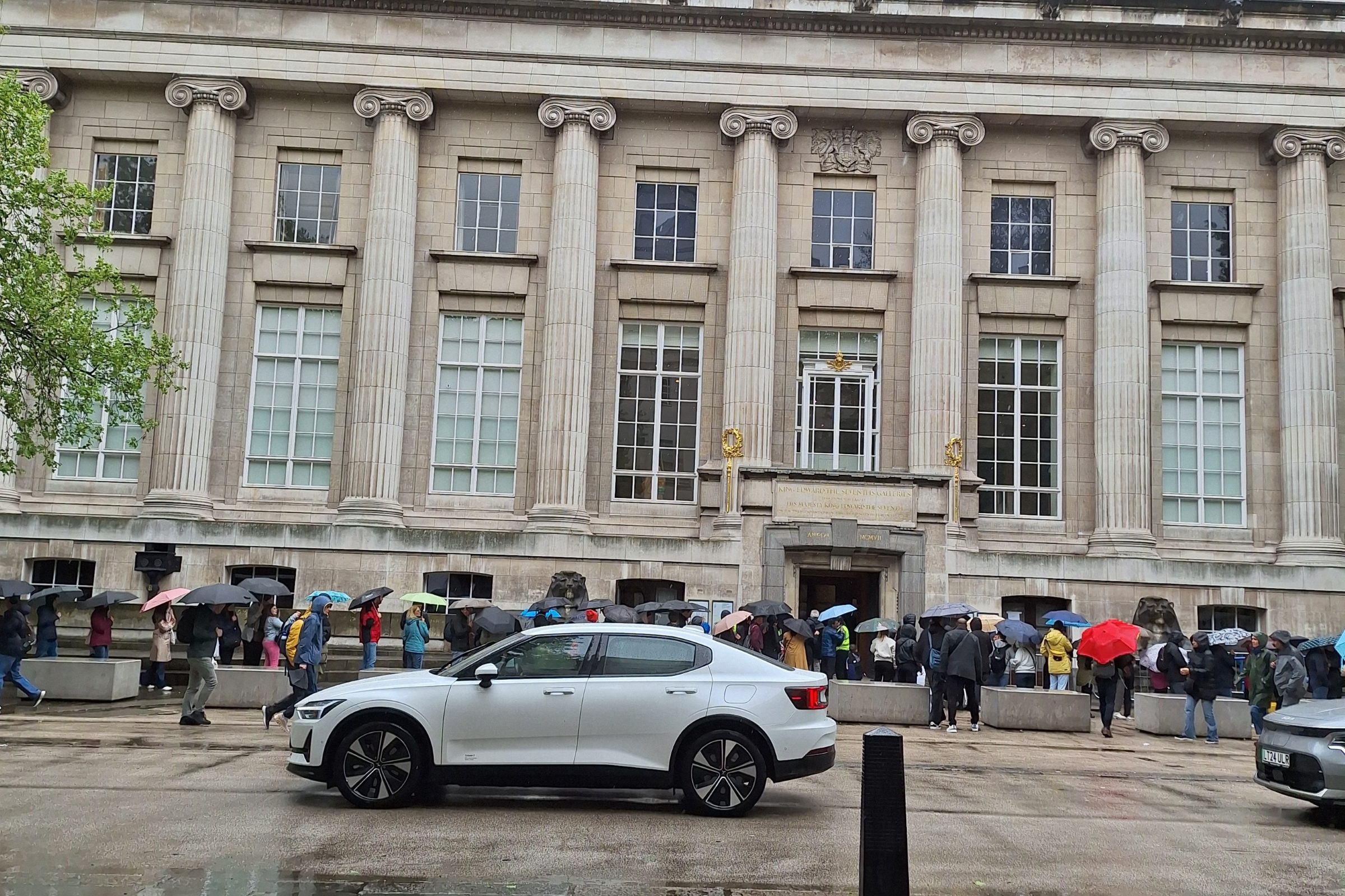Front of the British Museum in London on a rainy day, with people waiting outside